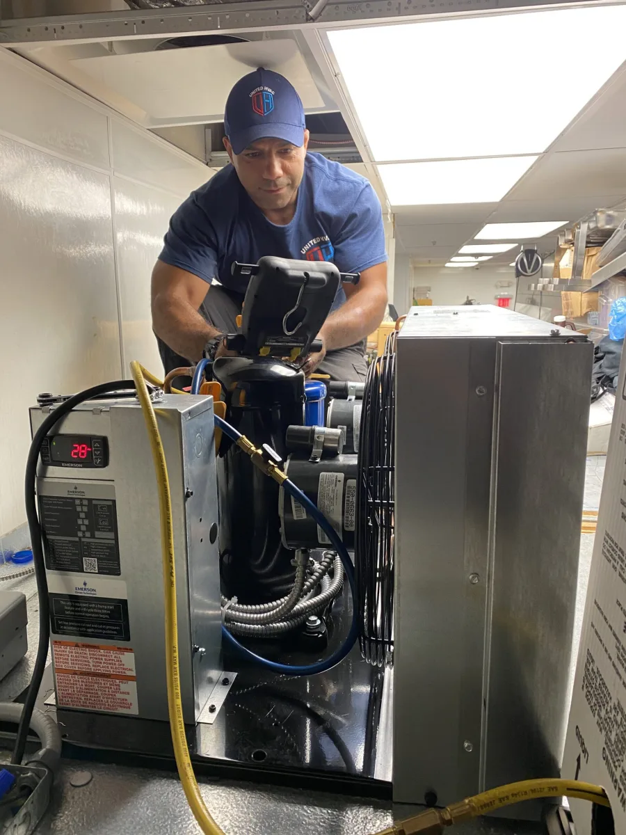 United HVAC owner Mahmoud Rashid servicing an HVAC system